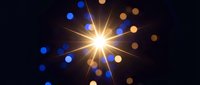 Bright golden starburst with radiating light rays and colorful bokeh circles on dark background for festive celebrations and holiday designs.