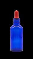 Cobalt blue glass dropper bottle with red rubber pipette cap, isolated on transparent background. Ready for cosmetics, essential oils, serums, and skincare product design use on packaging, labels, and print-on-demand materials.
