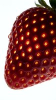 Ripe strawberry with glowing seeds isolated on white background, suitable for food packaging, culinary designs, and healthy eating concepts.