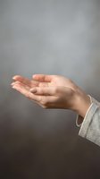 Open cupped hands in receiving gesture against neutral background, symbolizing hope, giving, protection and spiritual connection for wellness concepts.