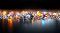 Sparkling diamonds and crystals scattered on reflective surface with colorful bokeh lights creating luxury jewelry background with copy space for text.
