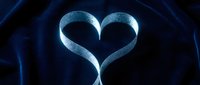 Glowing blue heart shape formed by curved light trails on dark background for romantic designs and love concepts.
