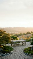 Peaceful zen garden with wooden bench surrounded by lush greenery, stones and gravel pathways during golden hour sunset for meditation and relaxation.