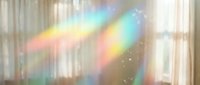 Dreamy rainbow light prisms casting colorful spectrum reflections through window with soft bokeh effects and magical sparkles for creative design projects.
