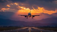 Commercial airplane approaching runway during dramatic sunset with mountain silhouettes and golden clouds for travel and aviation concepts.