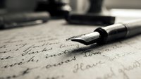 Fountain pen with nib resting on handwritten letter, vintage writing supplies for correspondence, literature, education, and creative writing projects.