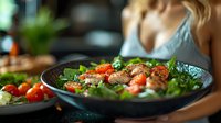 Fresh grilled chicken salad with cherry tomatoes and mixed greens served in dark plate, selective focus on vibrant ingredients. Healthy eating concept.
