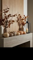 Autumn mantel display with white pumpkins, dried branches in vases and black lantern against wood paneling for seasonal home decor and interior design.