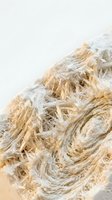 Natural jute rope fibers unraveled showing organic texture and neutral tones for sustainable craft projects and eco-friendly design applications.