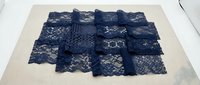 Navy blue lace fabric samples collection showcasing various intricate patterns and textures for fashion design, crafting, and textile applications.