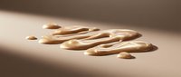 Elongated wooden spoons arranged in a diagonal pattern on a neutral beige surface with soft natural lighting and shadows.