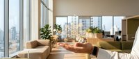 Modern luxury apartment living room with floor-to-ceiling windows showcasing city skyline views, contemporary furniture and natural lighting for upscale interior design.