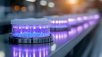 Glowing purple LED beacon light with reflective surface creates dramatic perspective line into distance. Modern safety and warning illumination system.