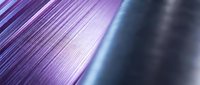 Abstract purple metallic surface with linear texture and gradient lighting effects creating modern technological background for digital design projects.