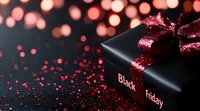 Black gift box with sparkly red bow against dark background with red bokeh lights and glitter, seasonal shopping concept for holiday sales and promotions.