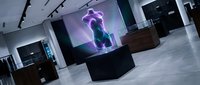 Modern museum gallery interior with holographic purple brain display on pedestal, futuristic exhibition space with track lighting and polished floors.