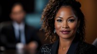 Confident African American woman with long curly hair wearing elegant black sequined top, professional portrait in corporate office setting with blurred male colleague in background.