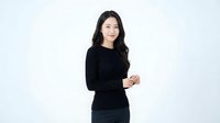 Young Asian businesswoman in black dress standing confidently against white background, professional portrait for corporate and business presentations.