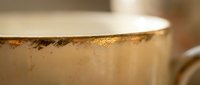 Close-up of golden coffee foam with rich crema texture in ceramic cup, morning beverage concept for cafe and restaurant marketing materials.