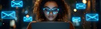 Young African American woman with curly hair and glasses illuminated by laptop screen at night, surrounded by glowing blue email icons and digital communication symbols.