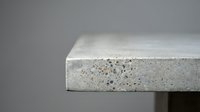 Modern concrete countertop edge detail showing natural aggregate texture and smooth finish for contemporary kitchen and bathroom design applications.