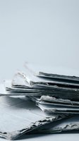 Stack of weathered vintage books with torn pages and damaged covers on neutral background for literary and educational projects.