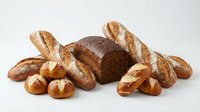 Assorted fresh baked bread loaves and rolls including whole wheat, baguettes and dinner rolls isolated on white background for bakery, food and culinary design projects.