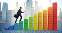 Professional businessman in dark suit climbing colorful bar chart steps against modern city skyline backdrop, symbolizing career growth and business success.