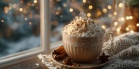 Hot chocolate with whipped cream and cinnamon sticks on cozy knit blanket by window with warm bokeh lights creating festive holiday atmosphere.