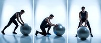 Athletic man performing dynamic fitness ball exercises in modern gym studio with dramatic lighting for strength training and core workout routines.
