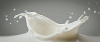 Dynamic milk splash with flowing droplets creating elegant crown shape against neutral background for dairy and beverage marketing campaigns.