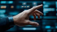 Male hand pointing at futuristic digital interface with glowing blue elements against dark background, demonstrating modern technology interaction and data control.