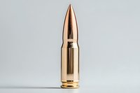 Shiny brass bullet with copper tip standing upright on light gray background, isolated ammunition cartridge for military, defense, and security concepts.