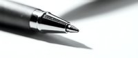 Professional black ballpoint pen tip in macro detail on white background for business writing and office documentation needs.