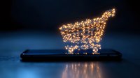 Glowing shopping cart icon made of lights floating above smartphone screen in dark blue environment, concept of mobile commerce and digital retail.