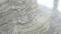 Natural marble stone surface with elegant veining patterns and crystalline texture for luxury interior design and architectural applications.