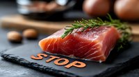 Raw salmon fillet with fresh rosemary sprig on black slate board, selective focus on fresh fish texture, natural food photography for restaurant menu.