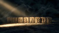 Wooden letter blocks spelling VARIABLE on dark surface with dramatic lighting and smoky atmosphere for business concepts and decision making presentations.