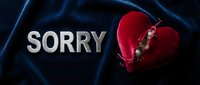 Broken red velvet heart with metal letters spelling SORRY on dark blue fabric, symbolizing apology, regret, and emotional healing in relationships.