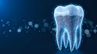 Digital tooth hologram with glowing particles on blue background for dental technology and healthcare innovation concepts.