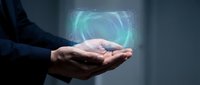 Businessman holding glowing digital hologram with blue circular technology interface, representing innovation, data transfer, and future business solutions.