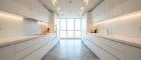 Modern galley kitchen with white cabinetry, minimalist design, and natural light from large windows. Ideal for interior design, home renovation, and real estate projects.