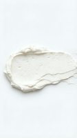 Creamy white cosmetic product smear with textured surface isolated on white background, suitable for skincare, beauty, and cosmetics design projects.