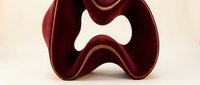 Modern burgundy abstract sculpture with flowing curves and golden edges on neutral background for contemporary interior design and artistic decoration.
