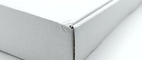 White cardboard box corner detail showing clean edges and professional packaging design for shipping and storage solutions.