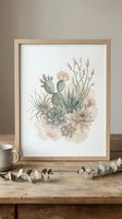 Watercolor succulent and cactus arrangement in wooden frame on rustic table with eucalyptus branches and coffee mug creating cozy home decor atmosphere.