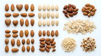 Assorted raw and roasted almonds, blanched almond slivers, and whole nuts arranged in organized groups on white background for culinary, nutritional, and food styling projects.