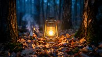 Vintage oil lantern glowing warmly among autumn leaves in dark forest setting, creating cozy atmospheric lighting for camping and outdoor adventures.