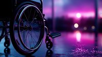Empty wheelchair silhouette against purple sunset sky with bokeh lights and water reflections on wet surface, creating atmospheric mood for healthcare concepts.