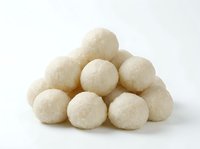 Pile of white round coconut balls or mochi sweets isolated on white background, ready for food packaging, bakery marketing, or culinary design projects.